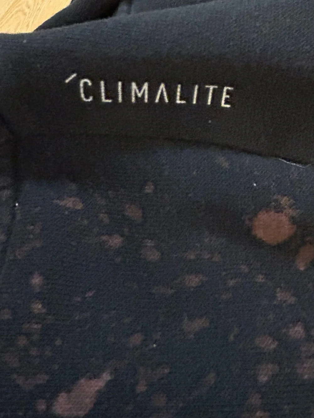 A upcycled, custom bleach-splattered Adidas crewneck sweatshirt